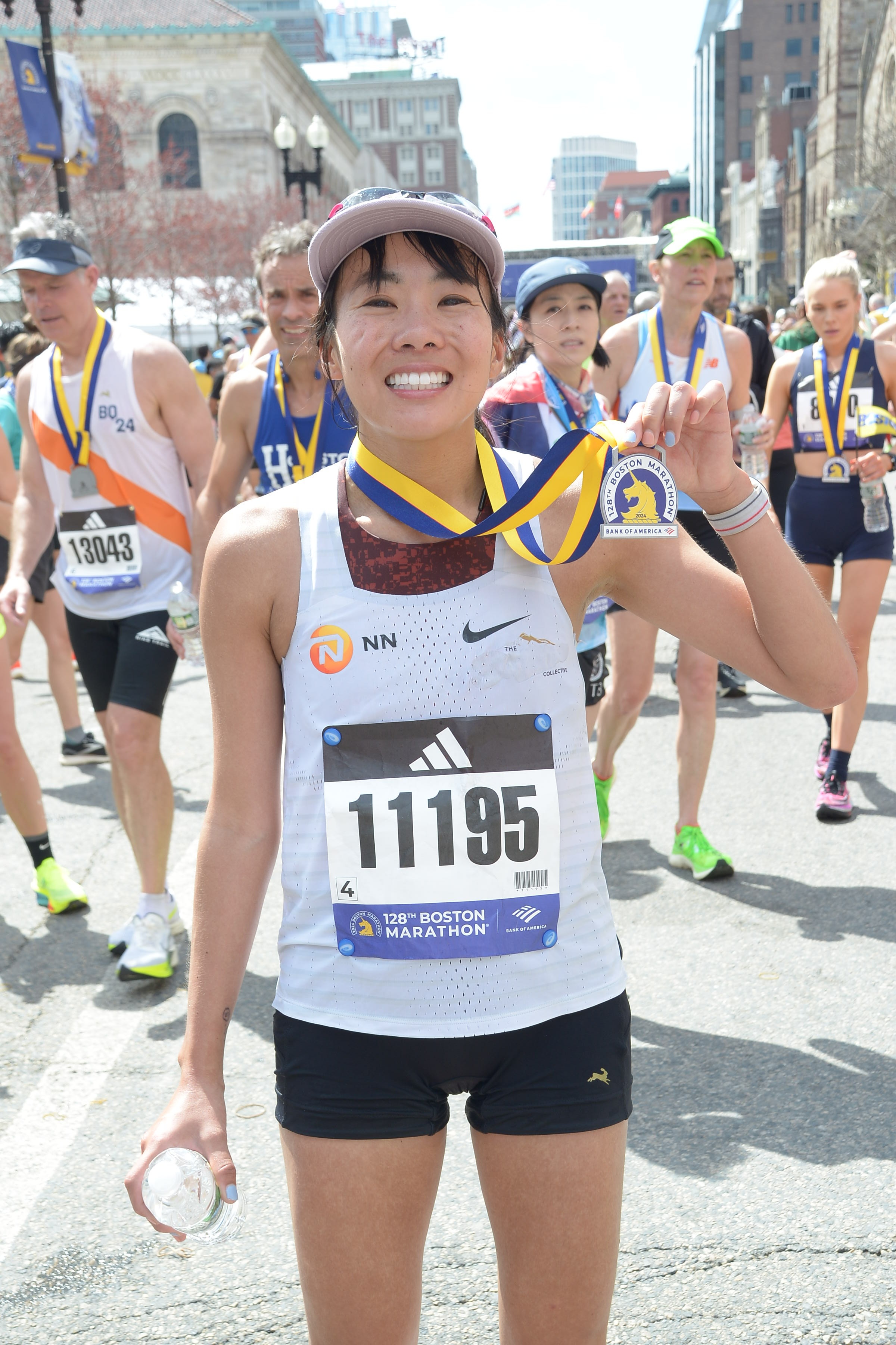 Holding medal at finish